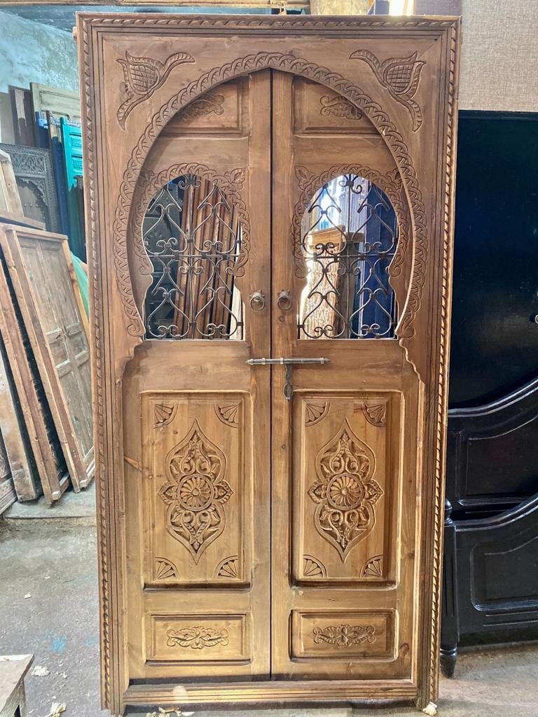 Traditional Moroccan wooden door, hand Carved door with two iron windows .