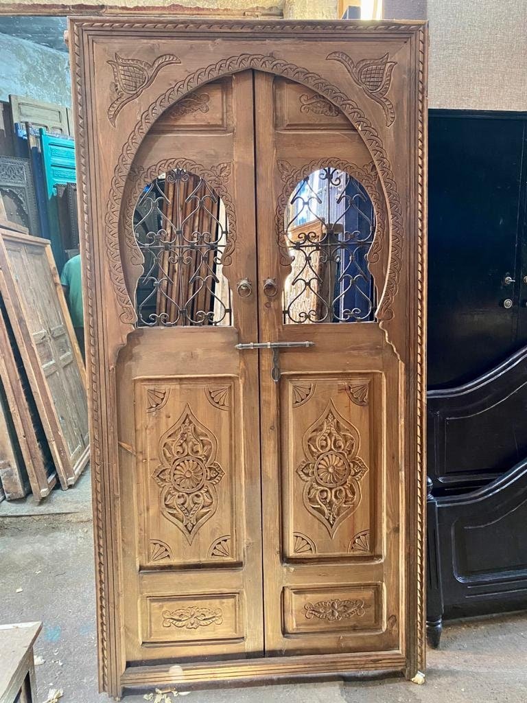 Traditional Moroccan wooden door, hand Carved door with two iron windows .