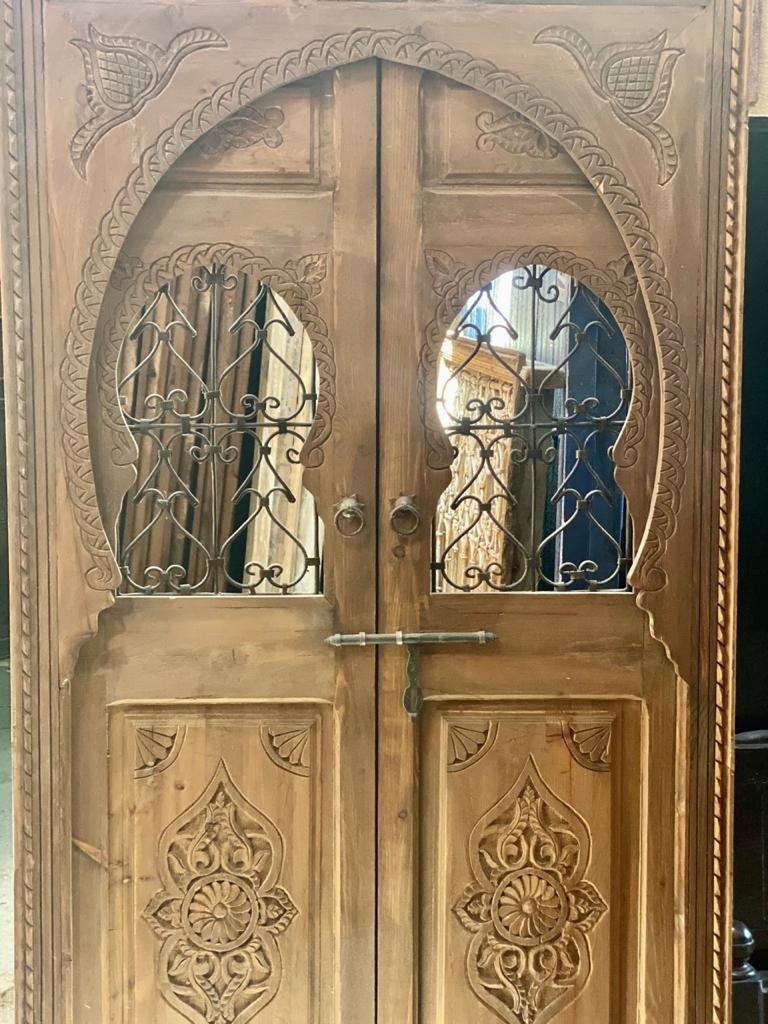 Traditional Moroccan wooden door, hand Carved door with two iron windows .