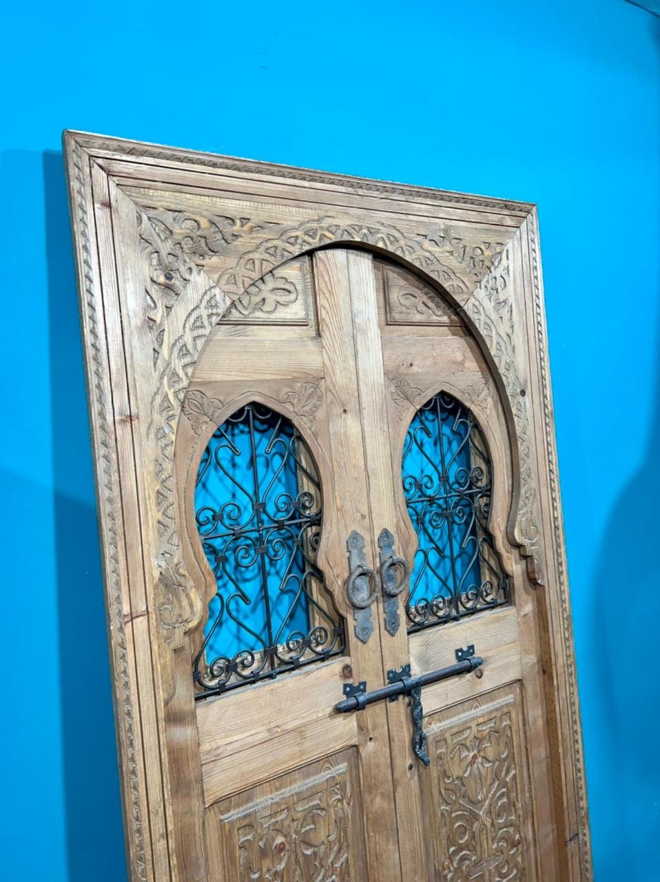 Traditional Moroccan door carved wooden door, with two windows in wrought iron worked a hand. wall decor.