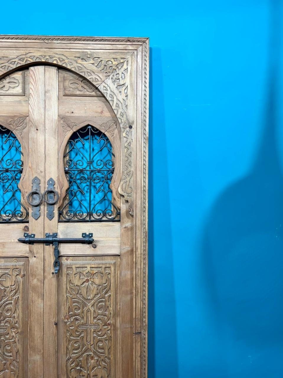 Traditional Moroccan door carved wooden door, with two windows in wrought iron worked a hand. wall decor.