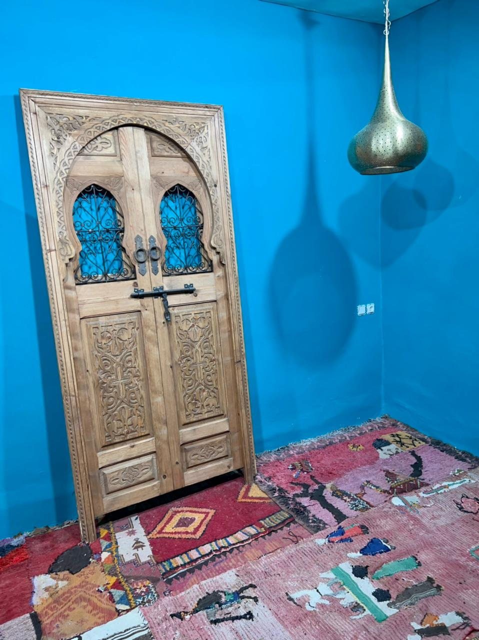 Traditional Moroccan door carved wooden door, with two windows in wrought iron worked a hand. wall decor.