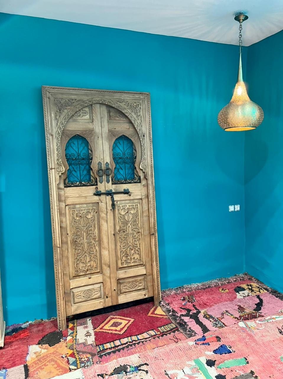 Traditional Moroccan door carved wooden door, with two windows in wrought iron worked a hand. wall decor.