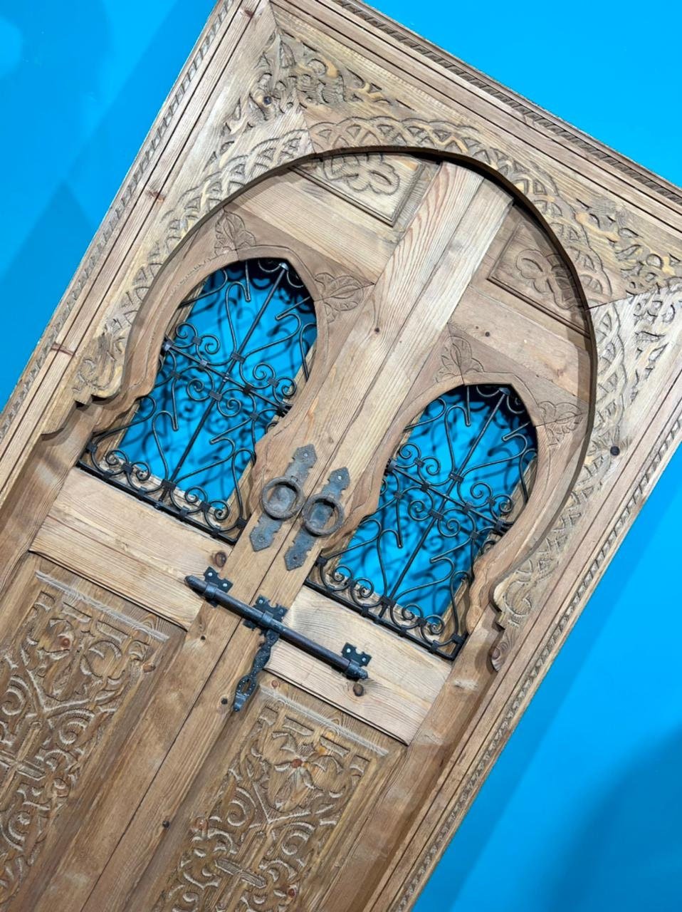 Traditional Moroccan door carved wooden door, with two windows in wrought iron worked a hand. wall decor.