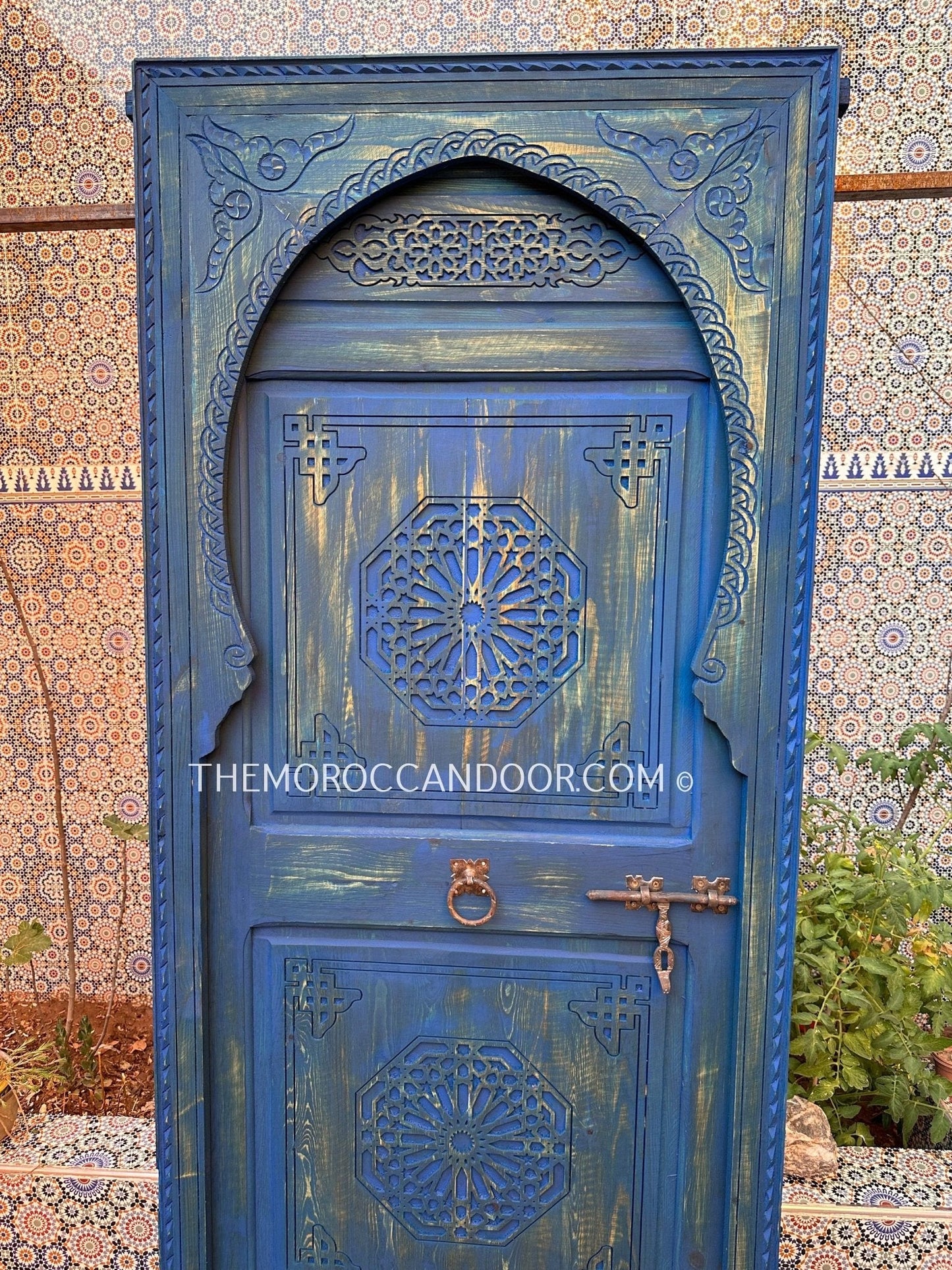 With This Custom Carved Moroccan Blue Door, you can bring the magic of Morocco into your home.