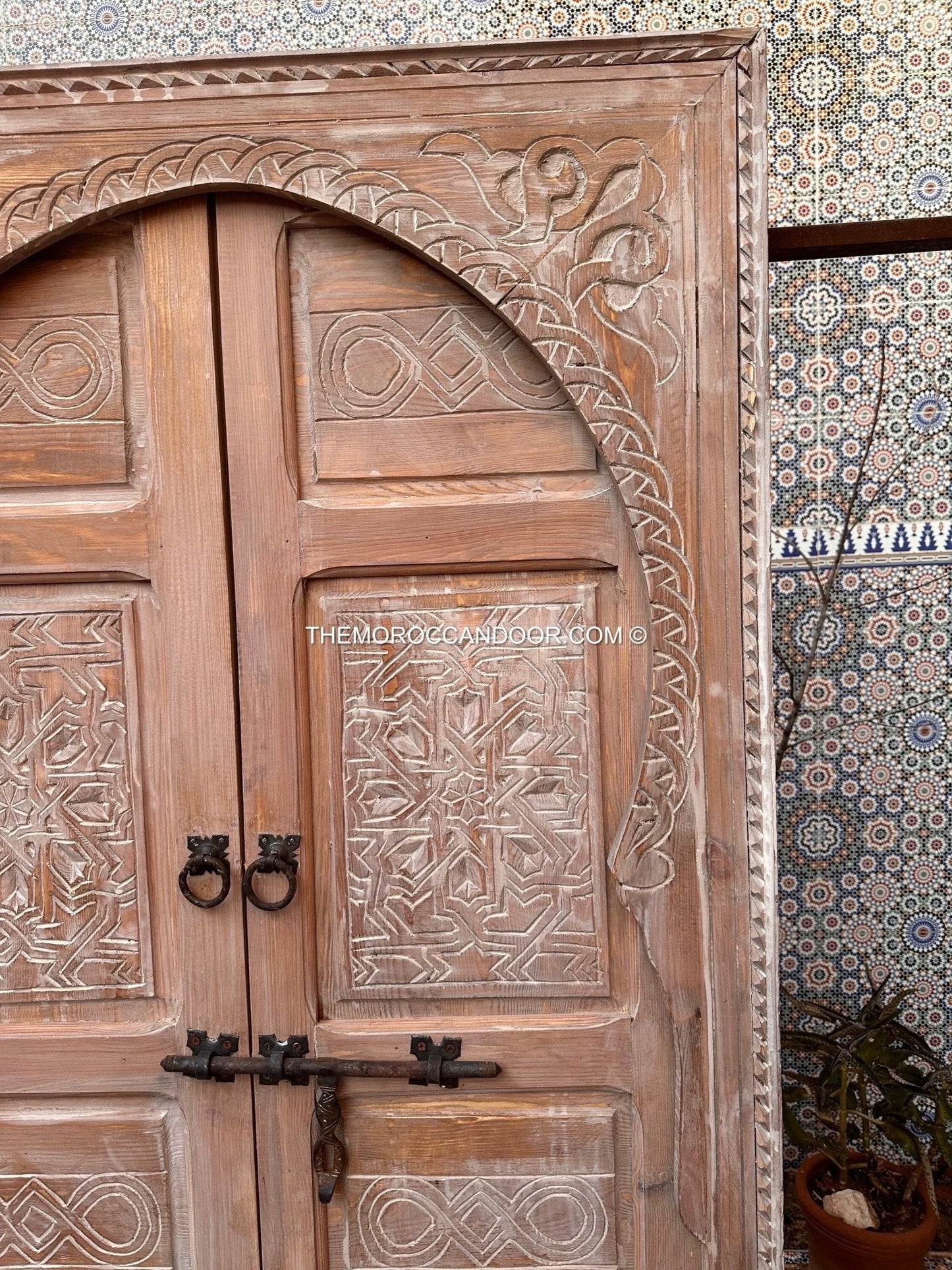 The tranquility and enchantment of Morocco enters your home through this exquisitely carved white door.